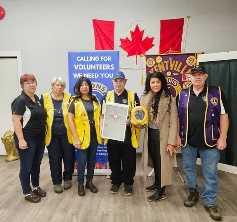 Kentville Lions Club members and a campaign representative with the donated AED and wall cabinet.