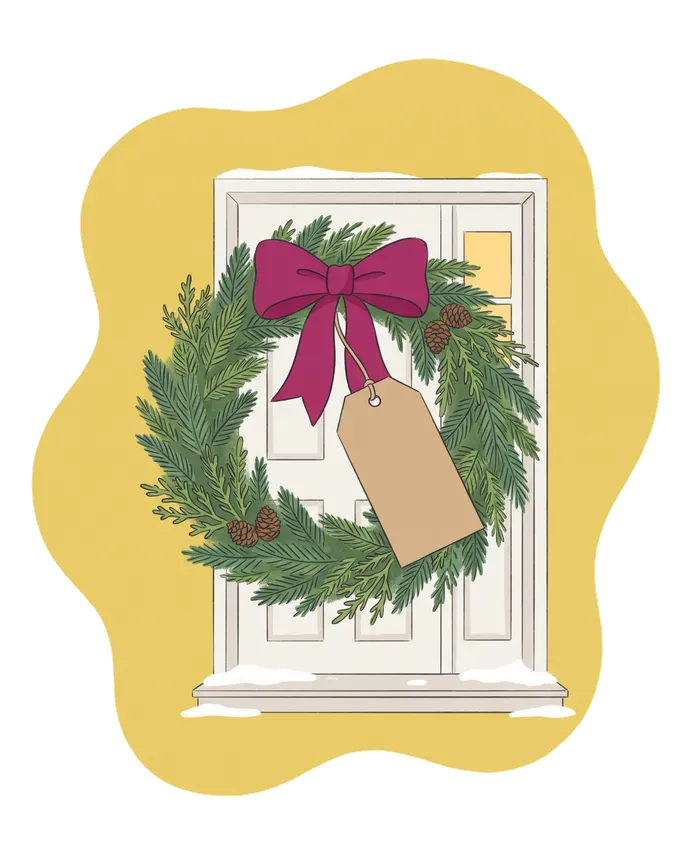 An evergreen Holiday Wreath with a deep pink bow and a blank gift tag hangs on a white front door, with a warm window beside it.